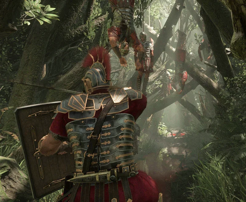 Cropped screenshot that shows Marius in a dark densely vegetated forest. Many bloody corpses of Roman soldiers hang from the trees.